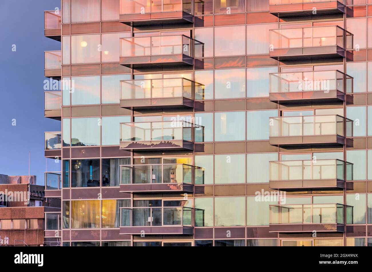 Rotterdam, The Netherlands, October 3, 2021: spectacular sky at sunset reflecting in the glass facade of a residential building in the Lijnbaan area Stock Photo