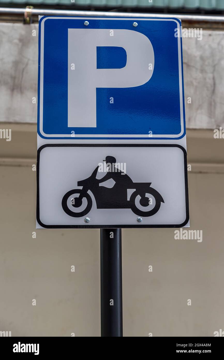 Blue Sign of motorbikes parking background Stock Photo - Alamy