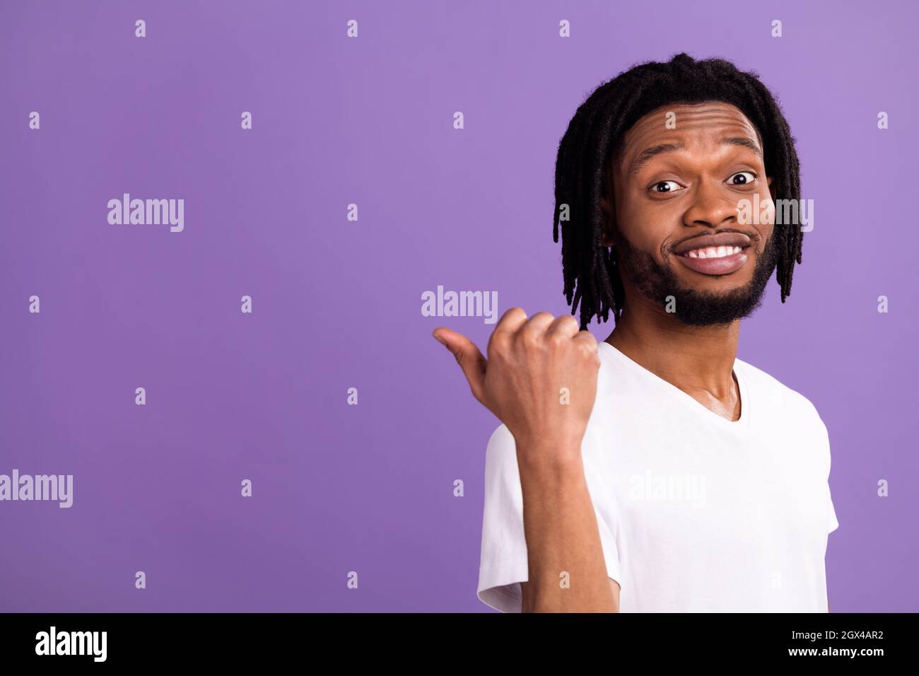 Photo of positive happy afro american man point finger thumb empty ...