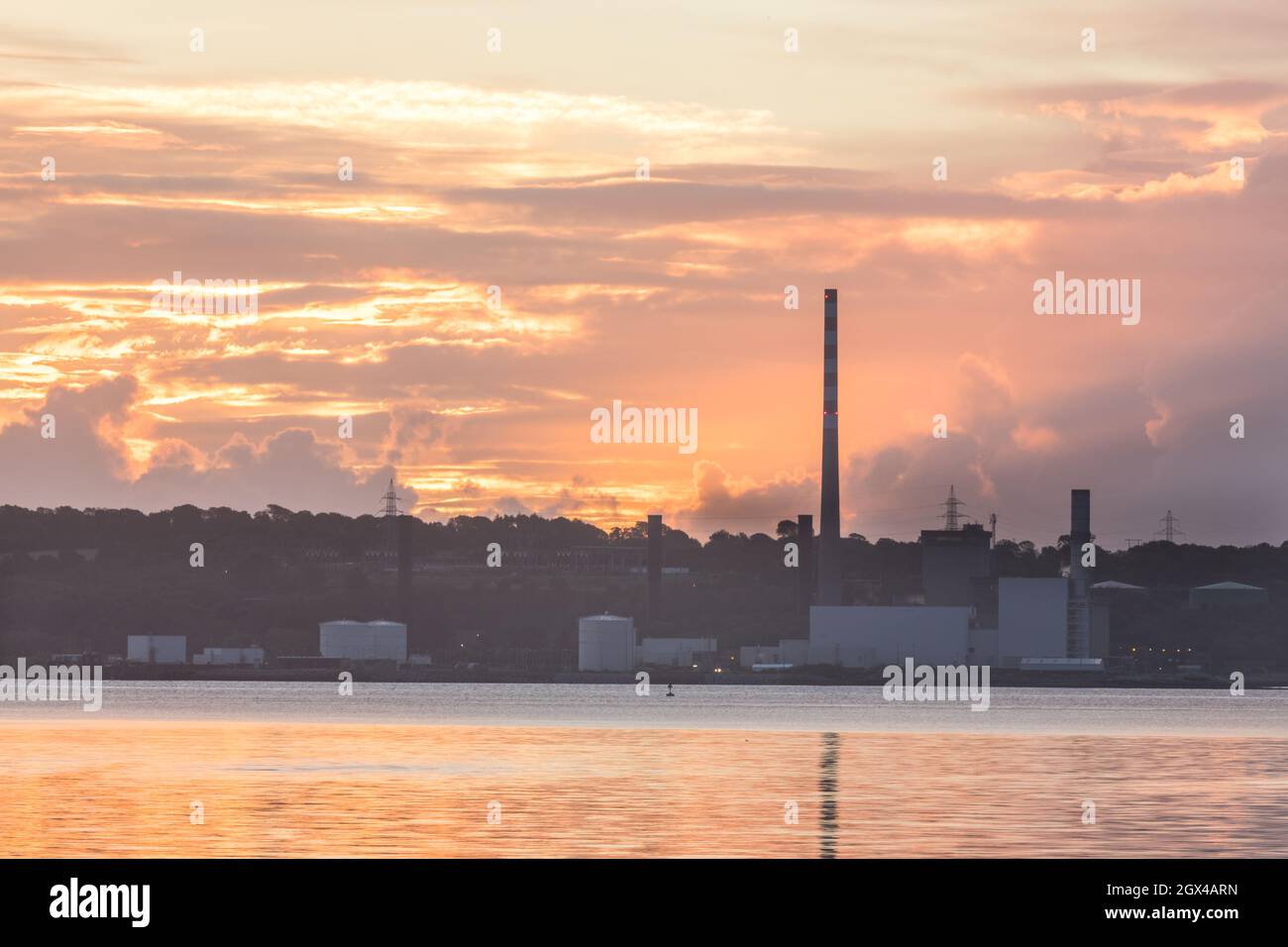 Aghada, Cork, Ireland. 04th October, 2021. Dawn begins to break over the ESB generating station in Aghada, Co. Cork, Ireland. - Picture; David Creedon / Alamy Live News Stock Photo