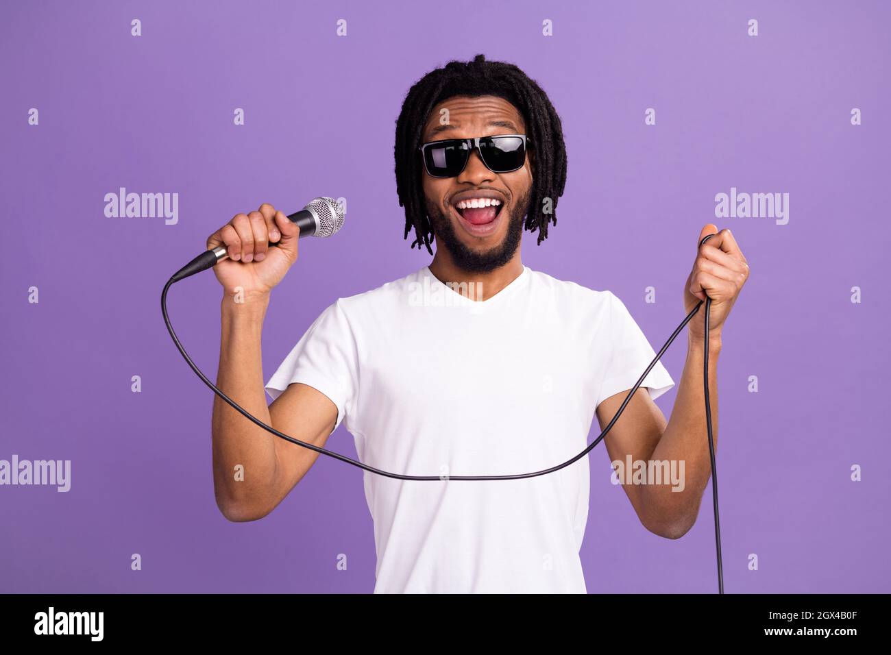 Photo of positive happy young dark skin man wear sunglass hold