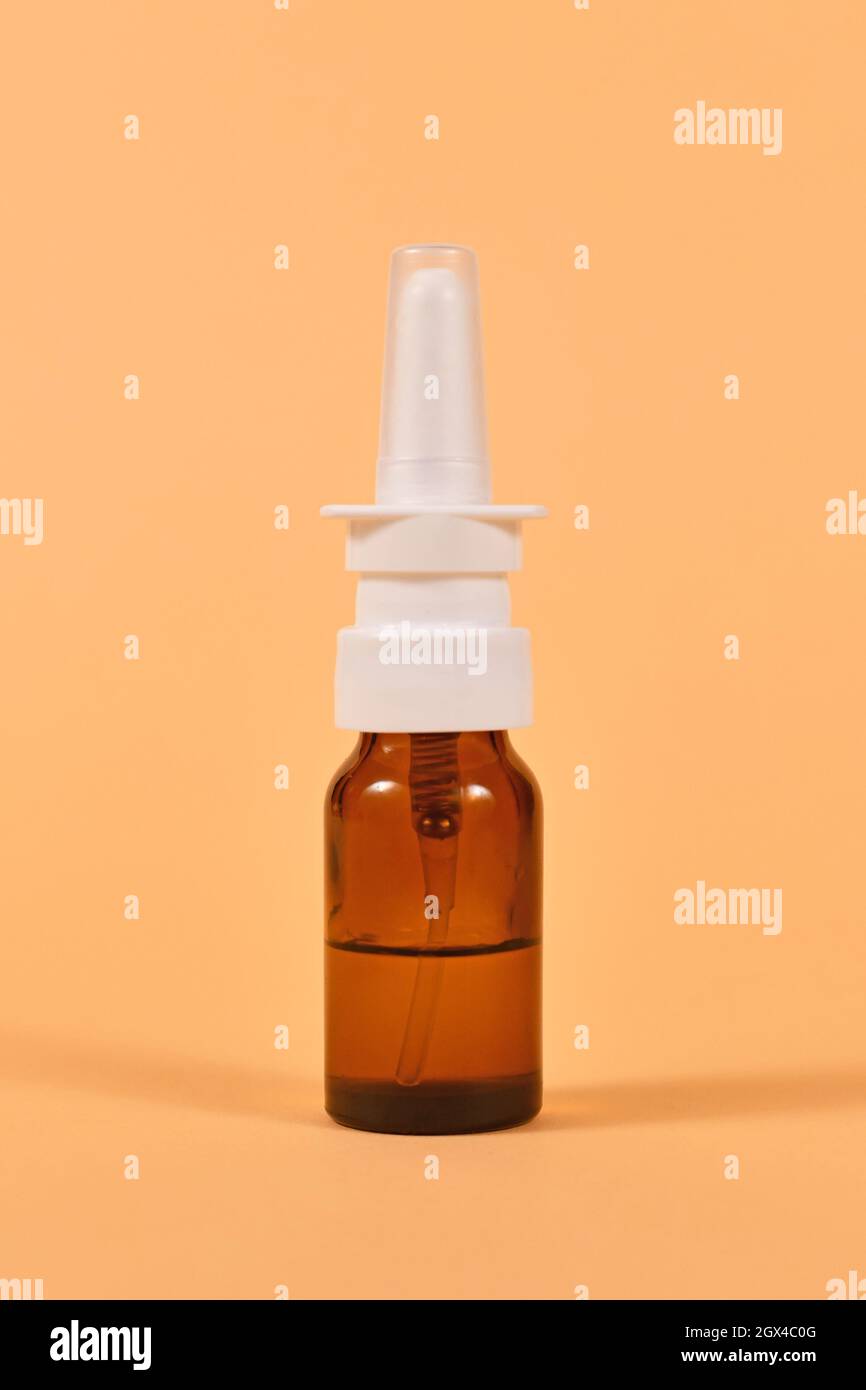 Brown glass nasal spray bottle on yellow background Stock Photo Alamy