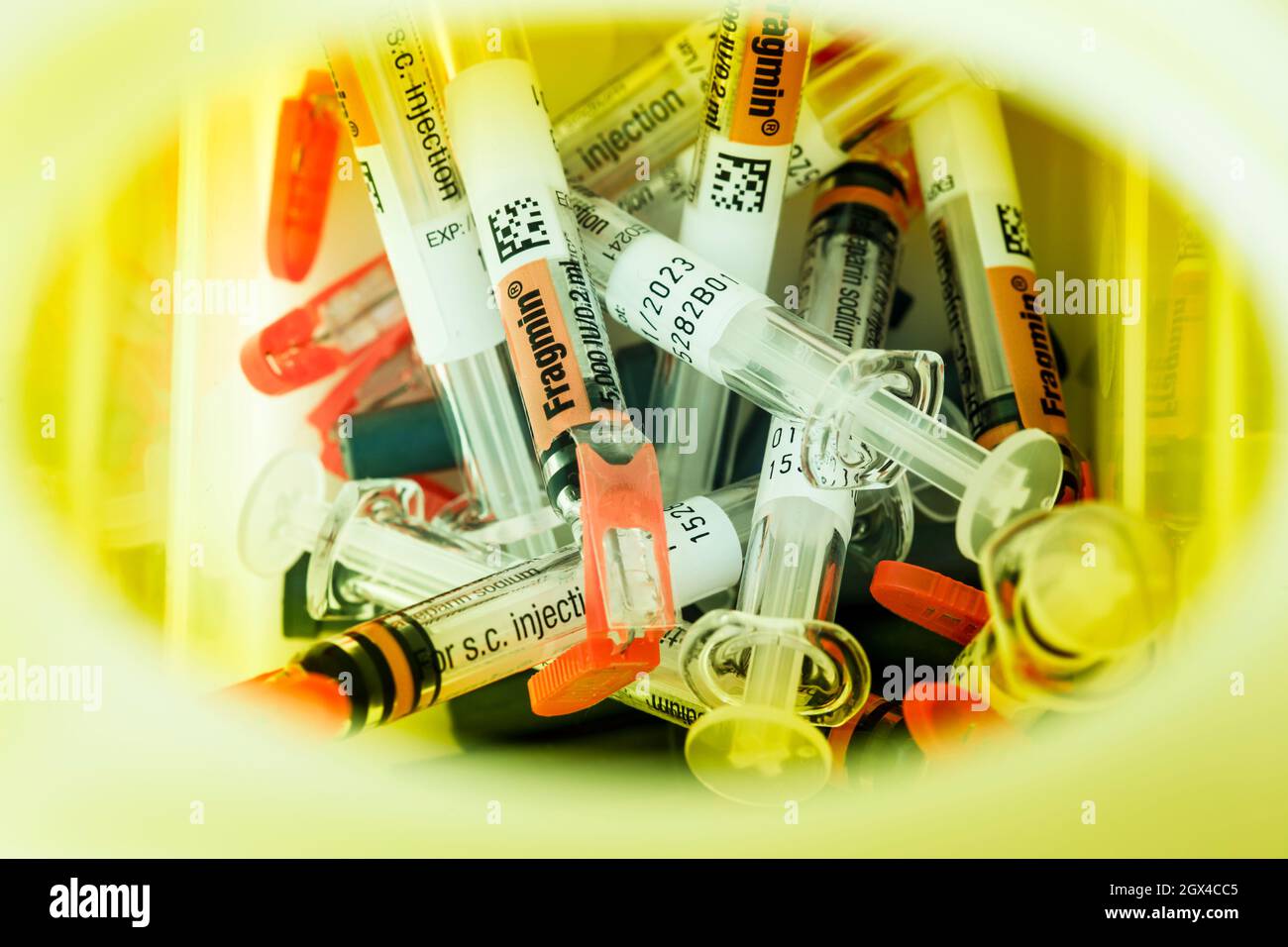 Used Fragmin syringes safely disposed of into a sharps box or sharpsafe Stock Photo