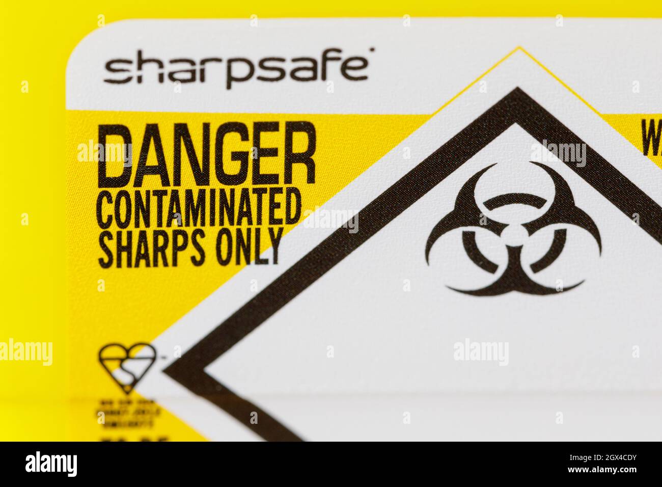 Sharpsafe or sharps box used for storing used syringes for disposal Stock Photo