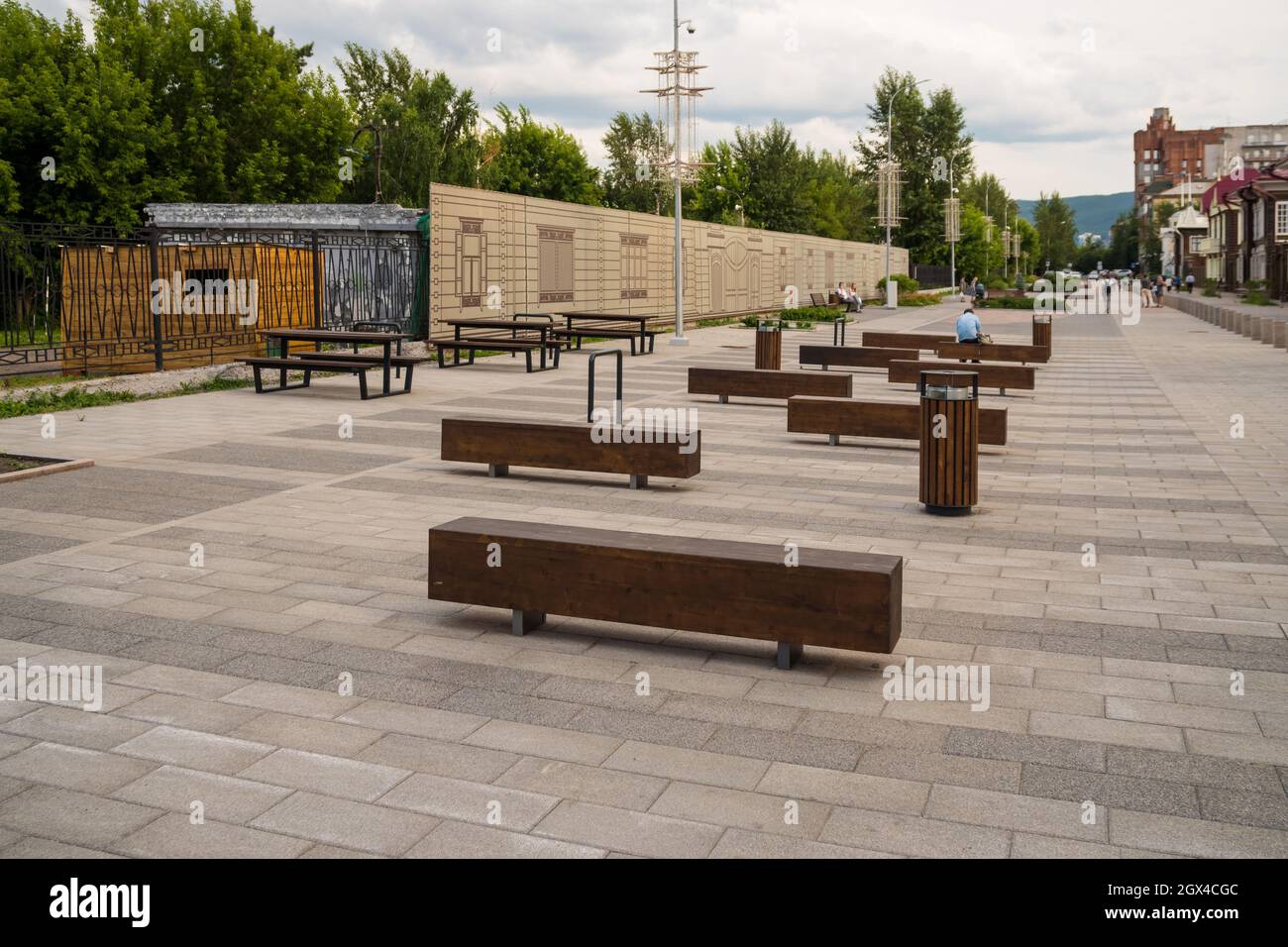 Benches for relaxation in the historic quarter of Gorky Street, opposite the old wooden houses, the turn of the XIX - XX centuries. Stock Photo
