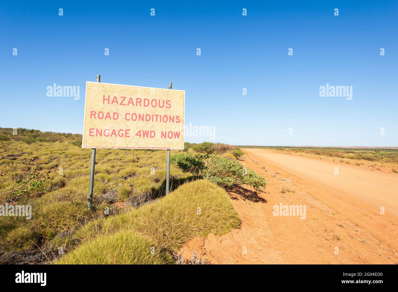 Road sign warning of hazardous road conditions on a gravel road in the