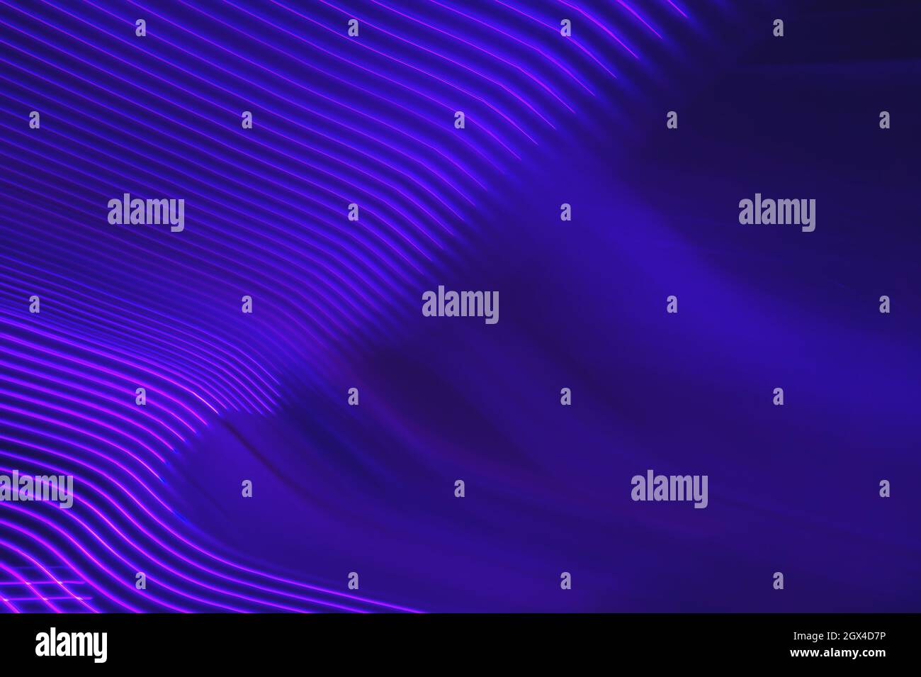 Neon purple light trails wavy pattern Stock Photo