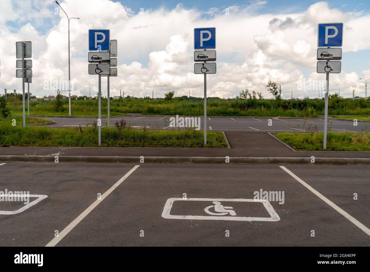 Parking spaces for disabled people with road signs, demarcated on the asphalt. Stock Photo