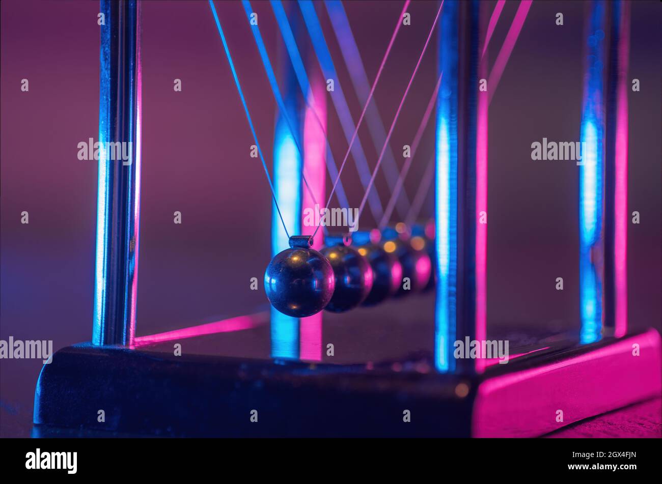 Newton cradle. Demonstrating gravity, action and reaction principle in