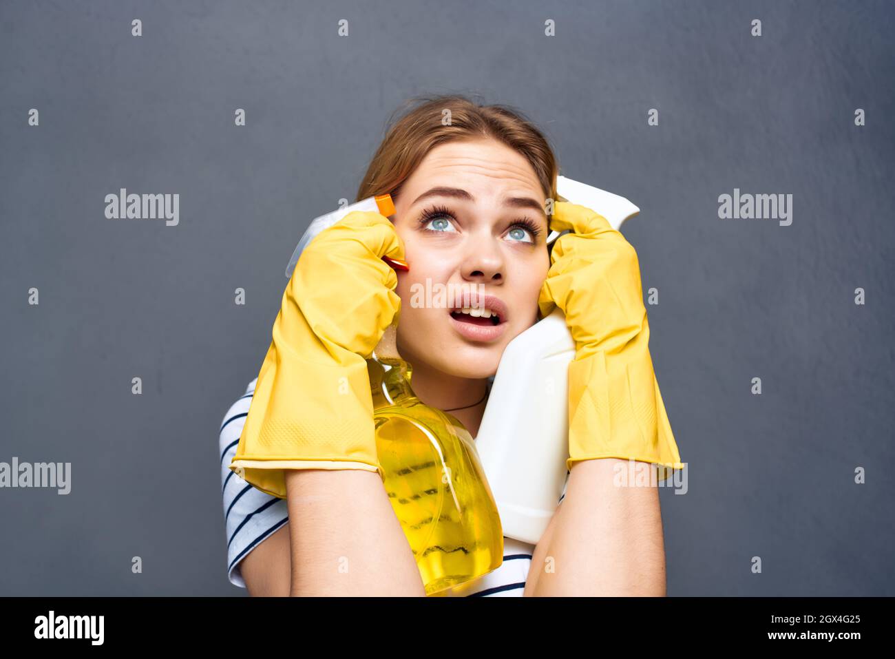 woman wearing yellow gloves detergent cleaning service housewife Stock