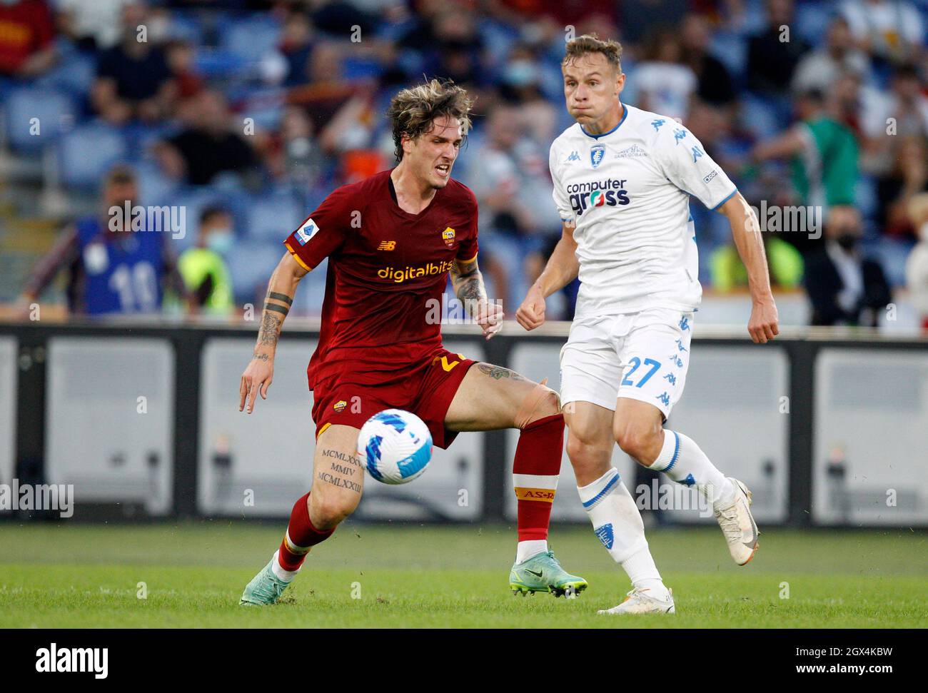 Rome, Italy. 3rd Oct, 2021. NicoloÕ Zaniolo, of AS Roma, left, is challenged by Szymon Zurkowski, of Empoli, during the Serie A football match between Roma and Empoli at the Olympic stadium. Credit: Riccardo De Luca - Update Images/Alamy Live News Stock Photo