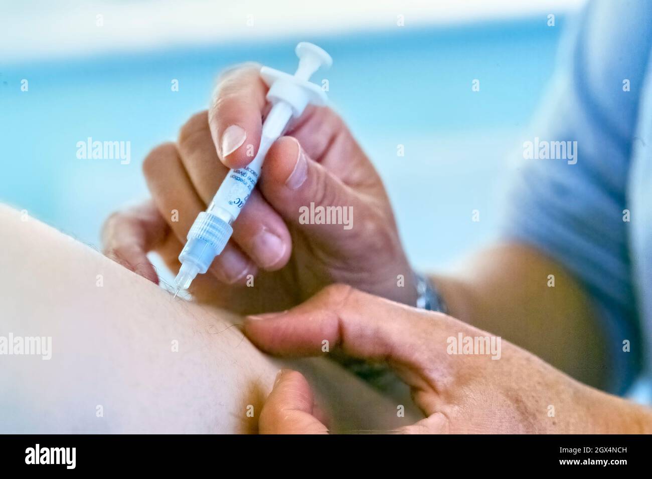 Influenza vaccination as an injection in the upper arm. Stock Photo
