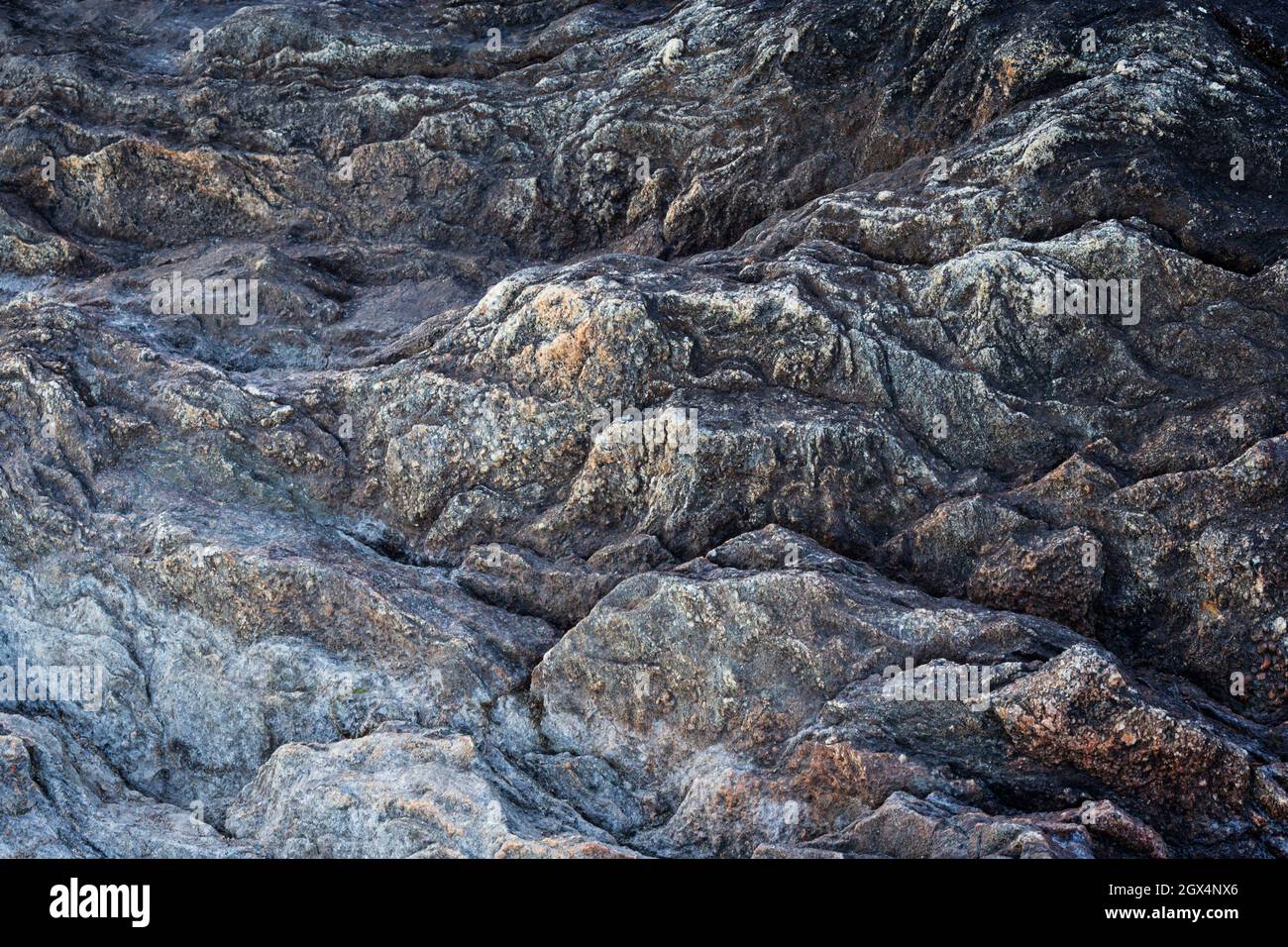 Close-up of a rough and rugged rock surface. Looks like a craggy