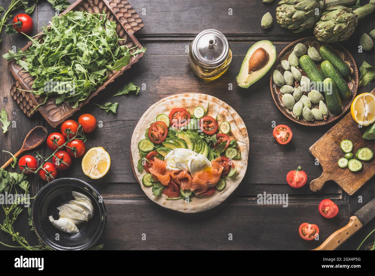 Tasty flatbread sandwich making with avocado, lettuce, mozzarella