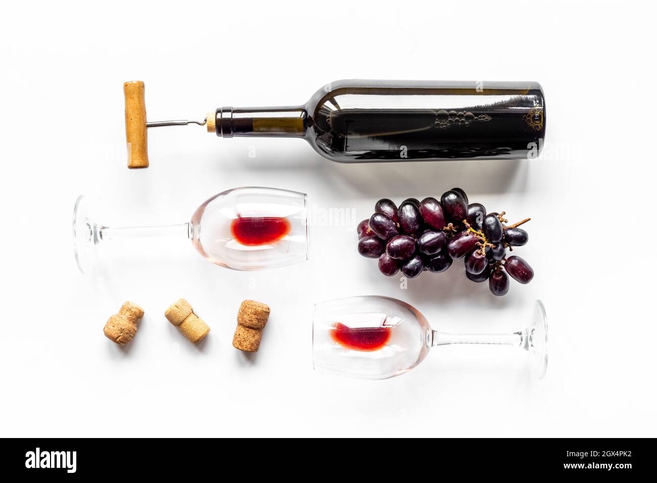 Red wine bottle with corkscrew and glasses. Top view Stock Photo