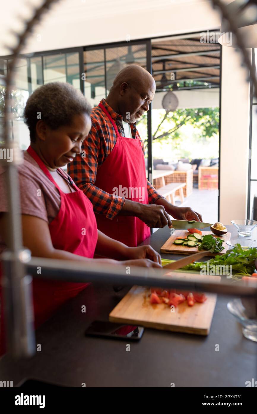 Happy african american senior couple cooking together in kitchen Stock ...