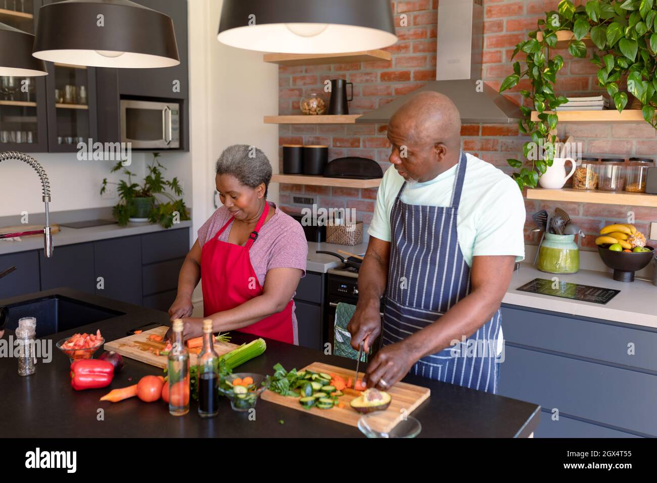 Happy african american senior couple cooking together in kitchen Stock ...
