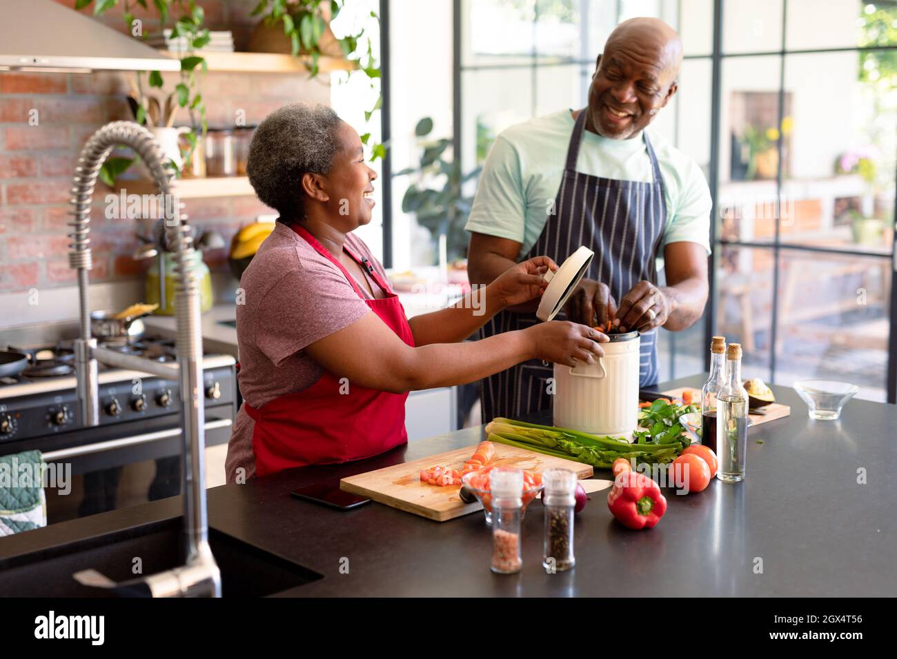 Happy african american senior couple cooking together in kitchen Stock ...
