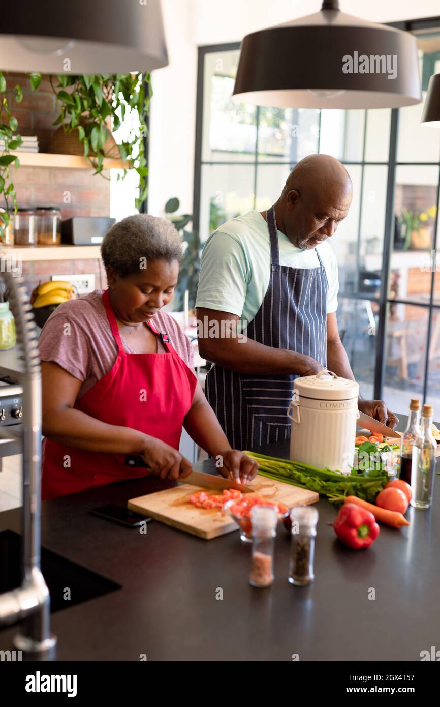 Happy african american senior couple cooking together in kitchen Stock ...