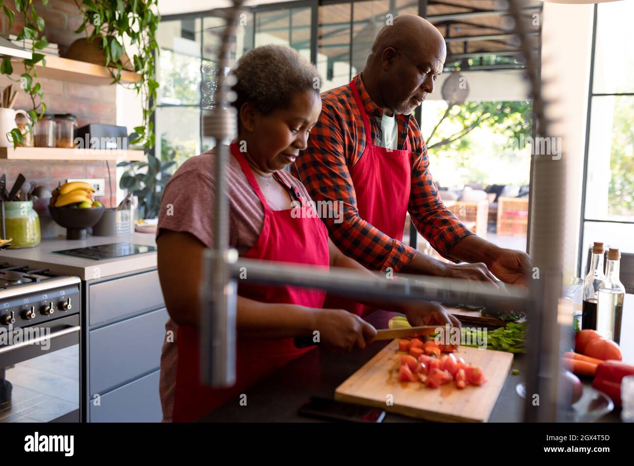 African american senior couple cooking together in kitchen Stock Photo ...