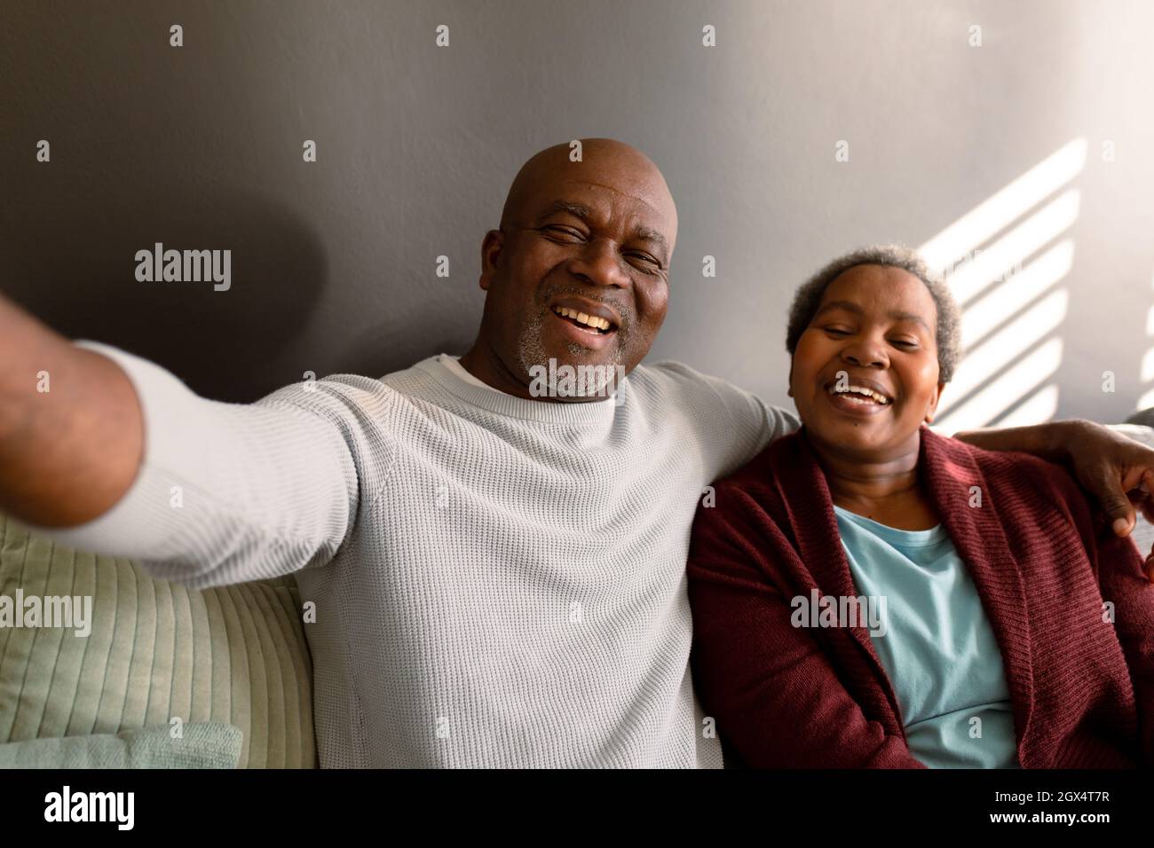 Happy african american senior couple taking selfie at home Stock Photo ...