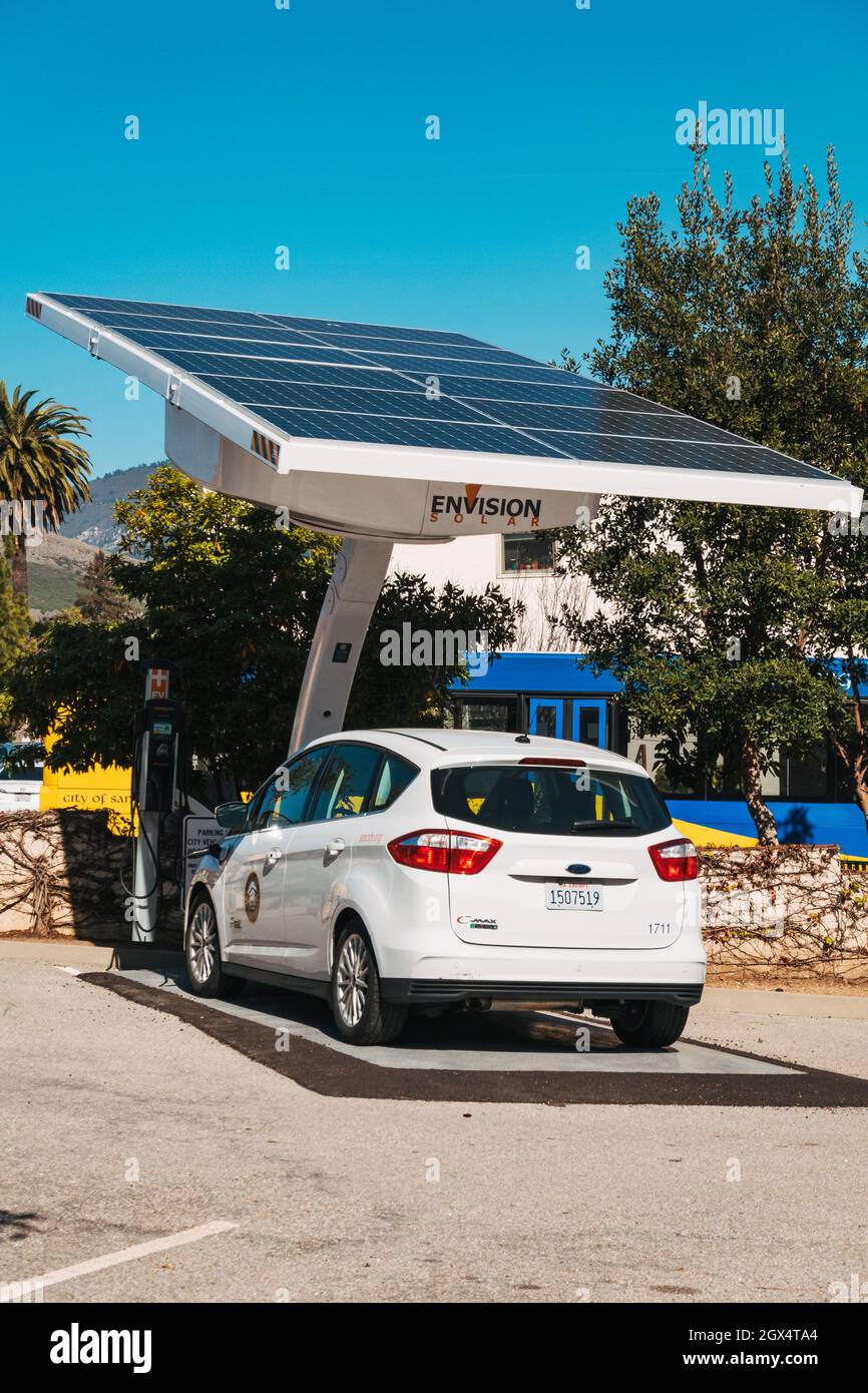A City of San Luis Obispo municipal electric vehicle recharges its battery from an Envision solar panel Stock Photo