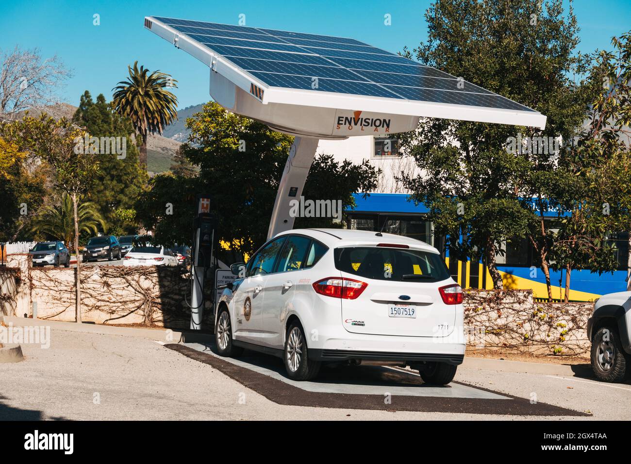 A City of San Luis Obispo municipal electric vehicle recharges its battery from an Envision solar panel Stock Photo