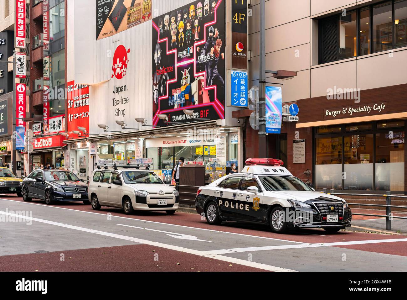 tokyo, japan - july 20 2021: Japanese police car with emergency beacons lights in stand by at the head of a traffic line in the tourist district of Ik Stock Photo