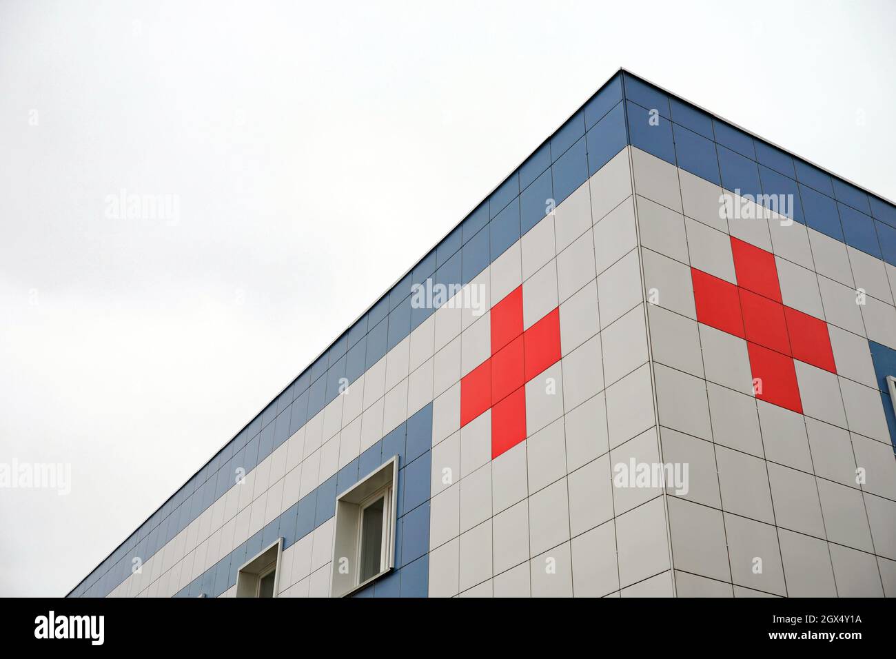 Celebrity momentum Traktor Medical symbol red cross on the cladding of the hospital building against  the background of the cloudy sky Stock Photo - Alamy
