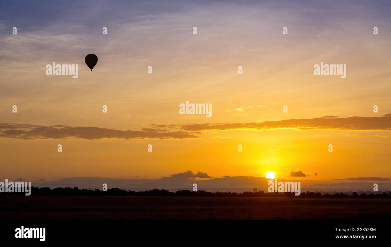 Balloon ride over the Masai Mara at sunrise. Popular tourist activity to get an aerial view of the wildlife and savannah. Stock Photo