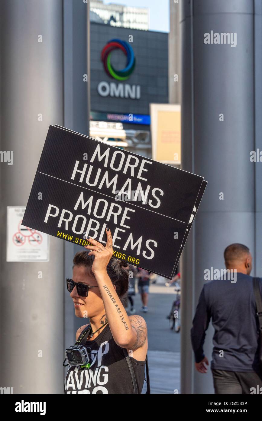 Supporter of the 'Stop Having Kids' movement with signs in the Yonge-Dundas Square in the downtown district of Toronto City, Canada. Stock Photo