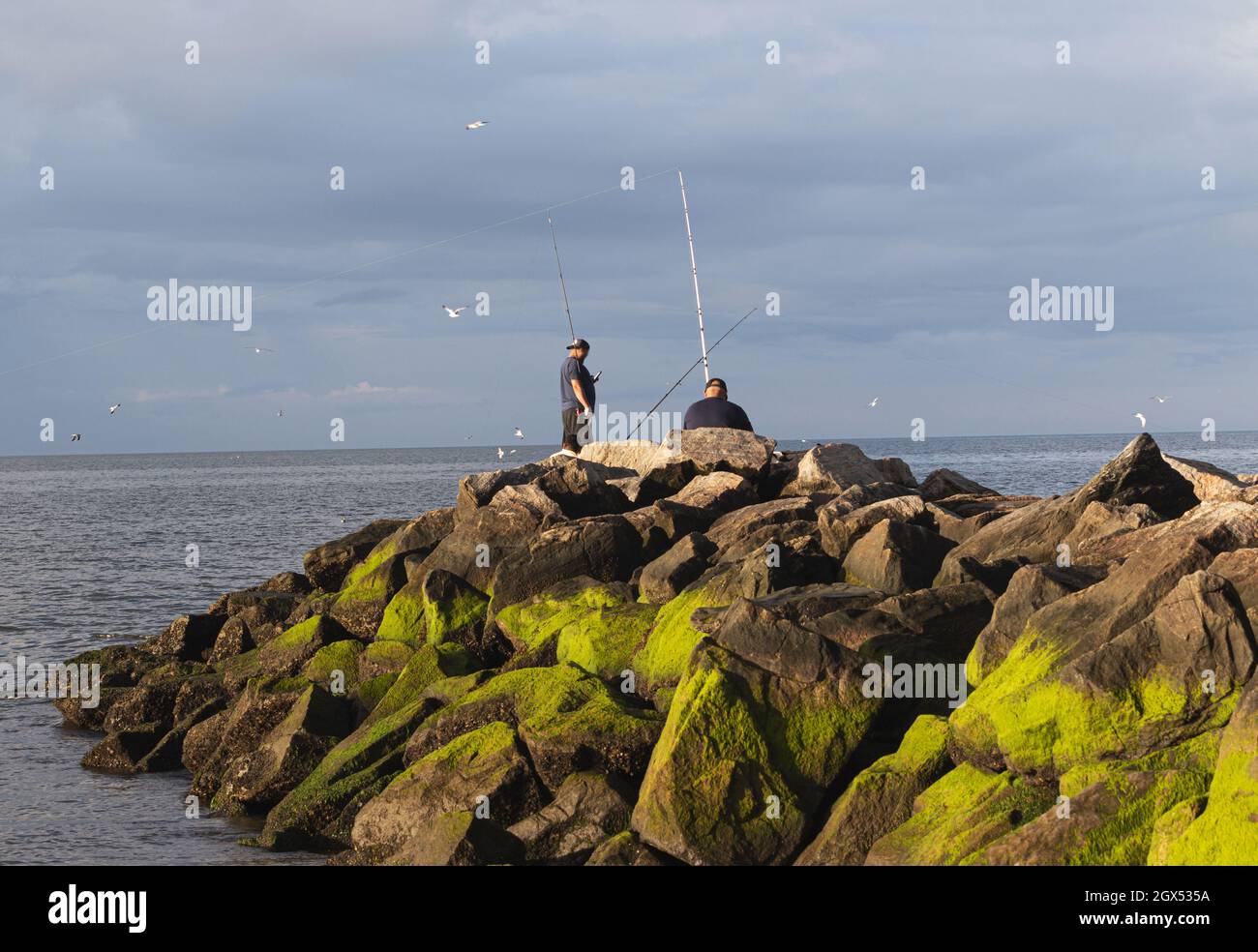 Two men are fishing on the rocks at Sunken Medow State Park with ...
