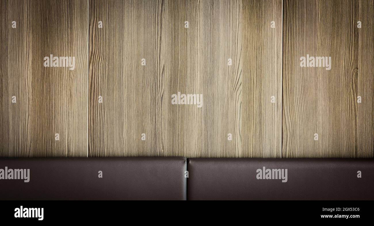 Wooden wall background with leather board. Stock Photo