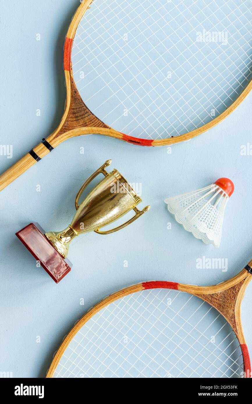 Small golden trophy cup with badminton rackets and shuttlecock for ...