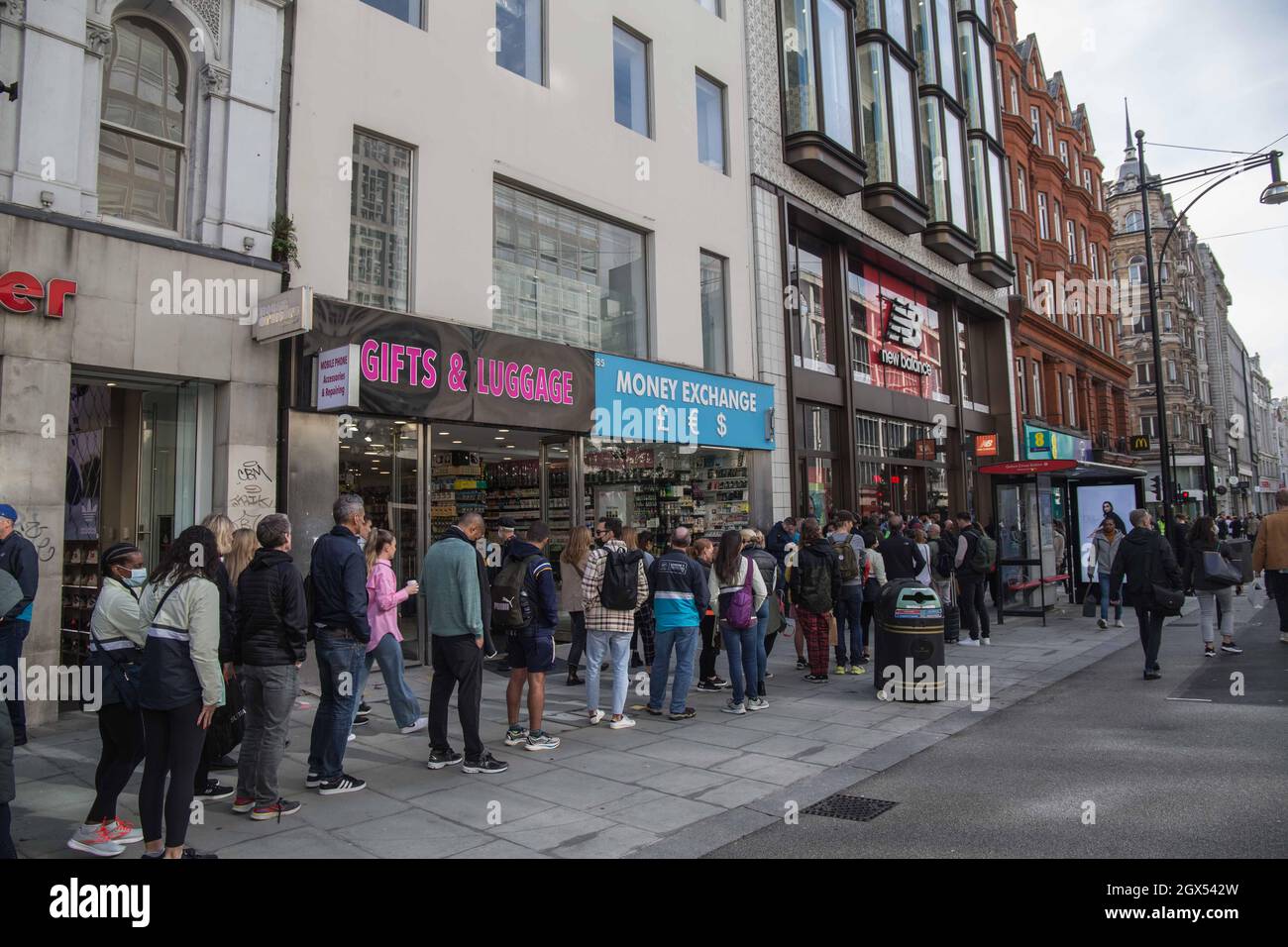 London UK 4 October 2021 Long queues formed outside New Balance store in  Oxford street ,were they were offering to engrave winners medals of the  London marathon runners ,with their names and