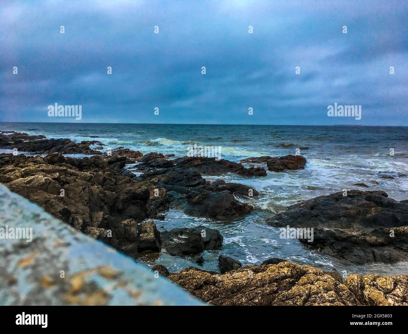 Cloudy day on a rocky beach Stock Photo - Alamy