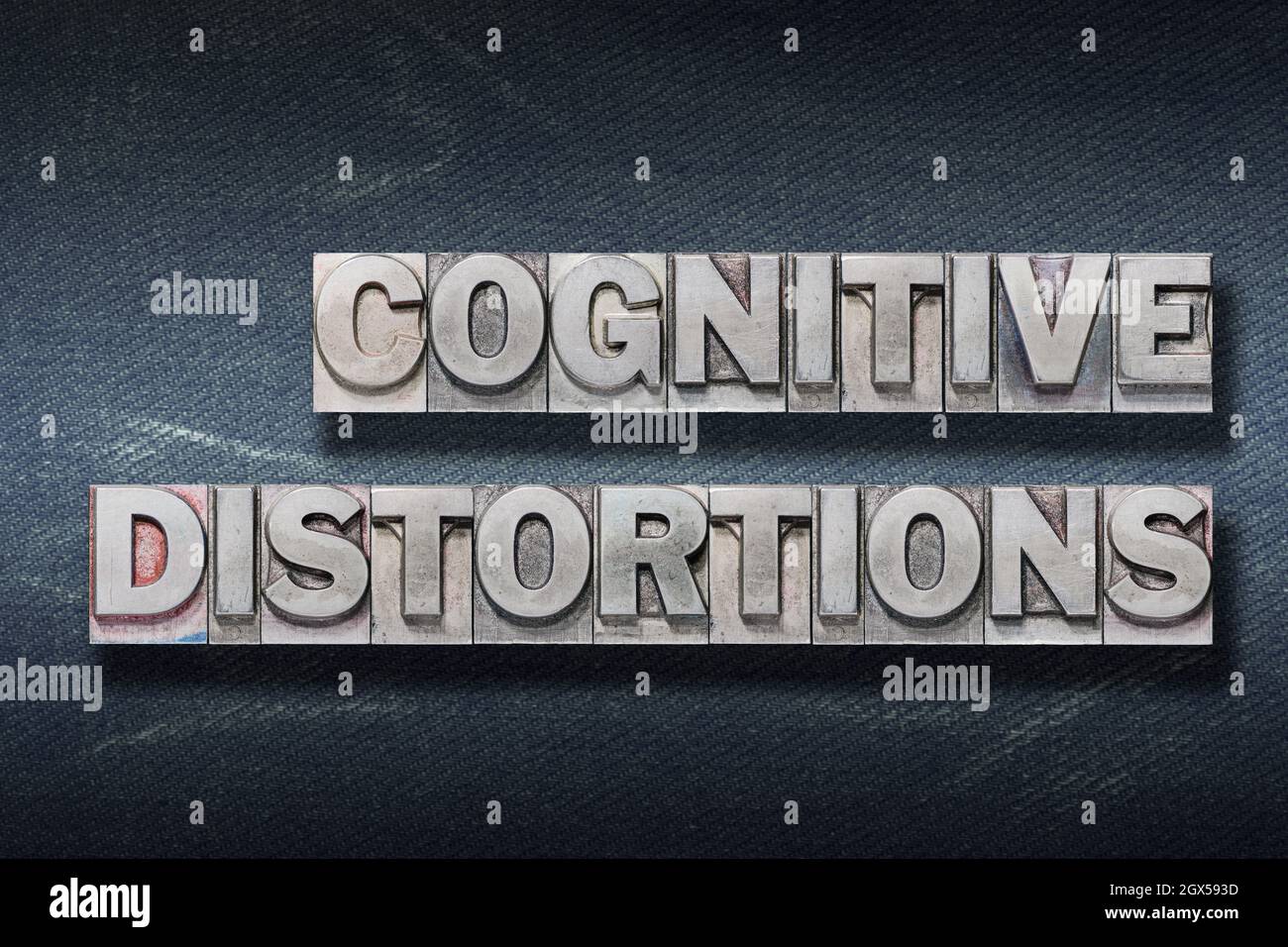 cognitive distortions phrase made from metallic letterpress on dark jeans background Stock Photo