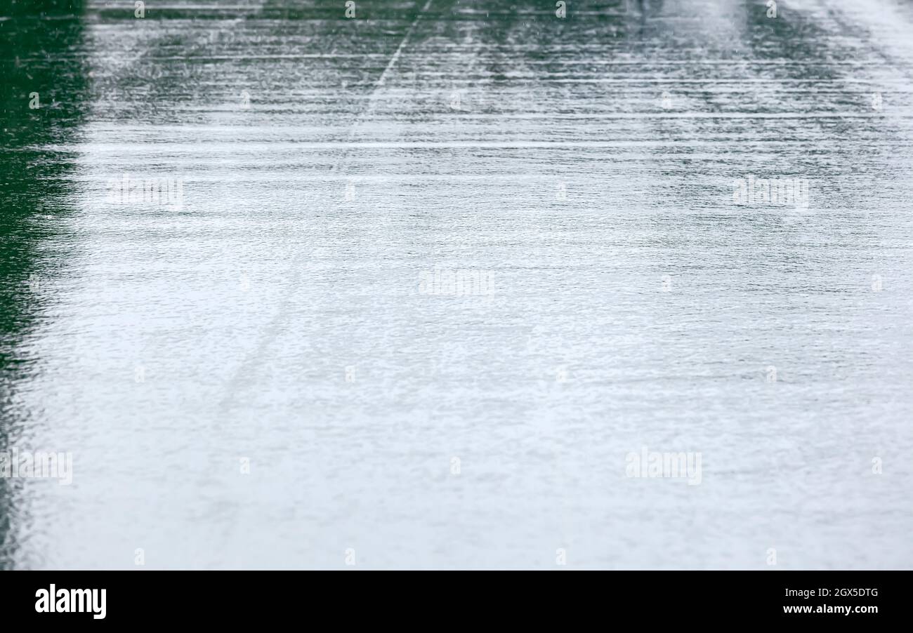 wet asphalt city road after rain with sky reflections. rainy weather in the city Stock Photo
