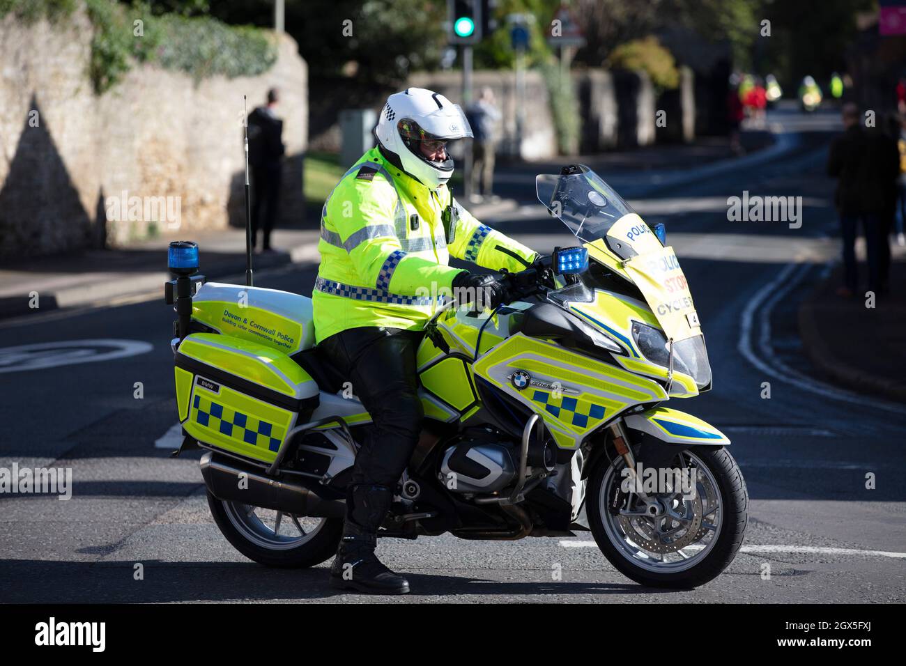 Bicester, UK - October 2021: Police motorbike rider blocks a road during an event Stock Photo