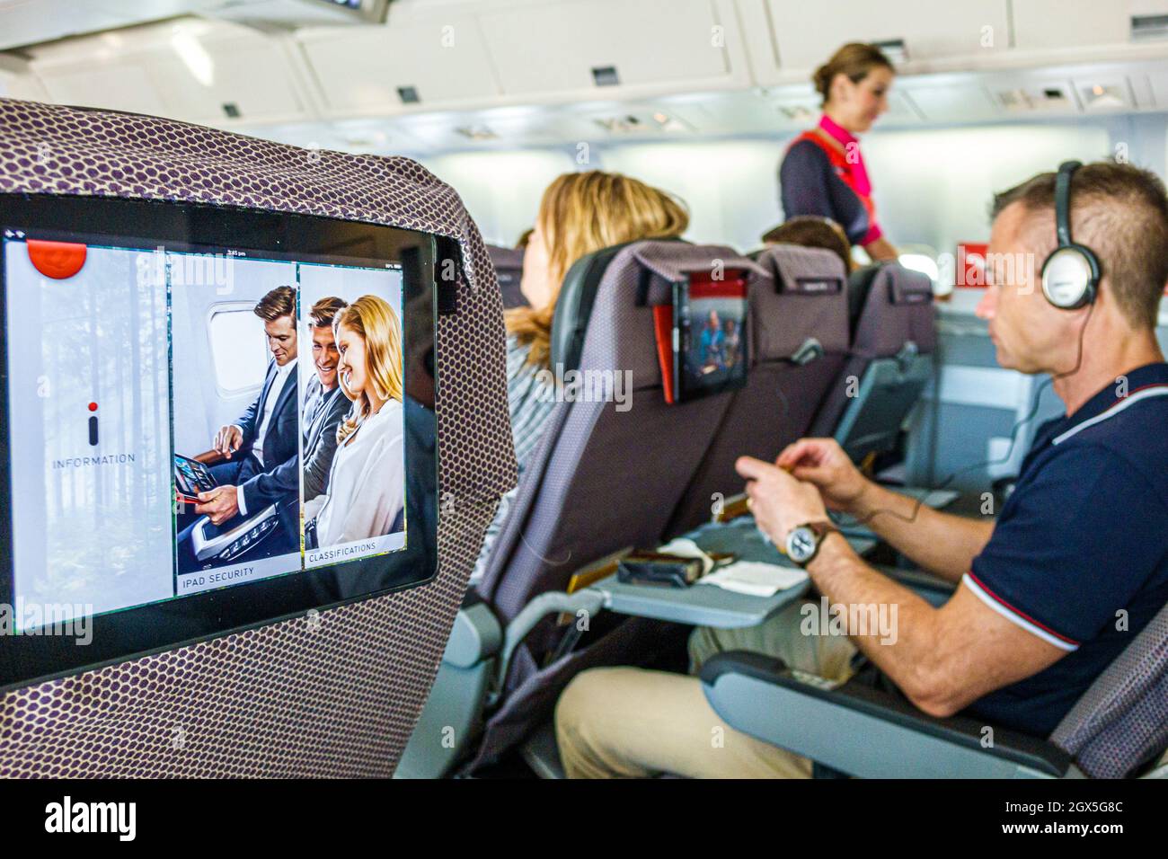 Sydney Australia,Kingsford-Smith Airport,Qantas Airlines,onboard cabin inside interior flight Brisbane,provided iPad passengers seats passenger cabin Stock Photo