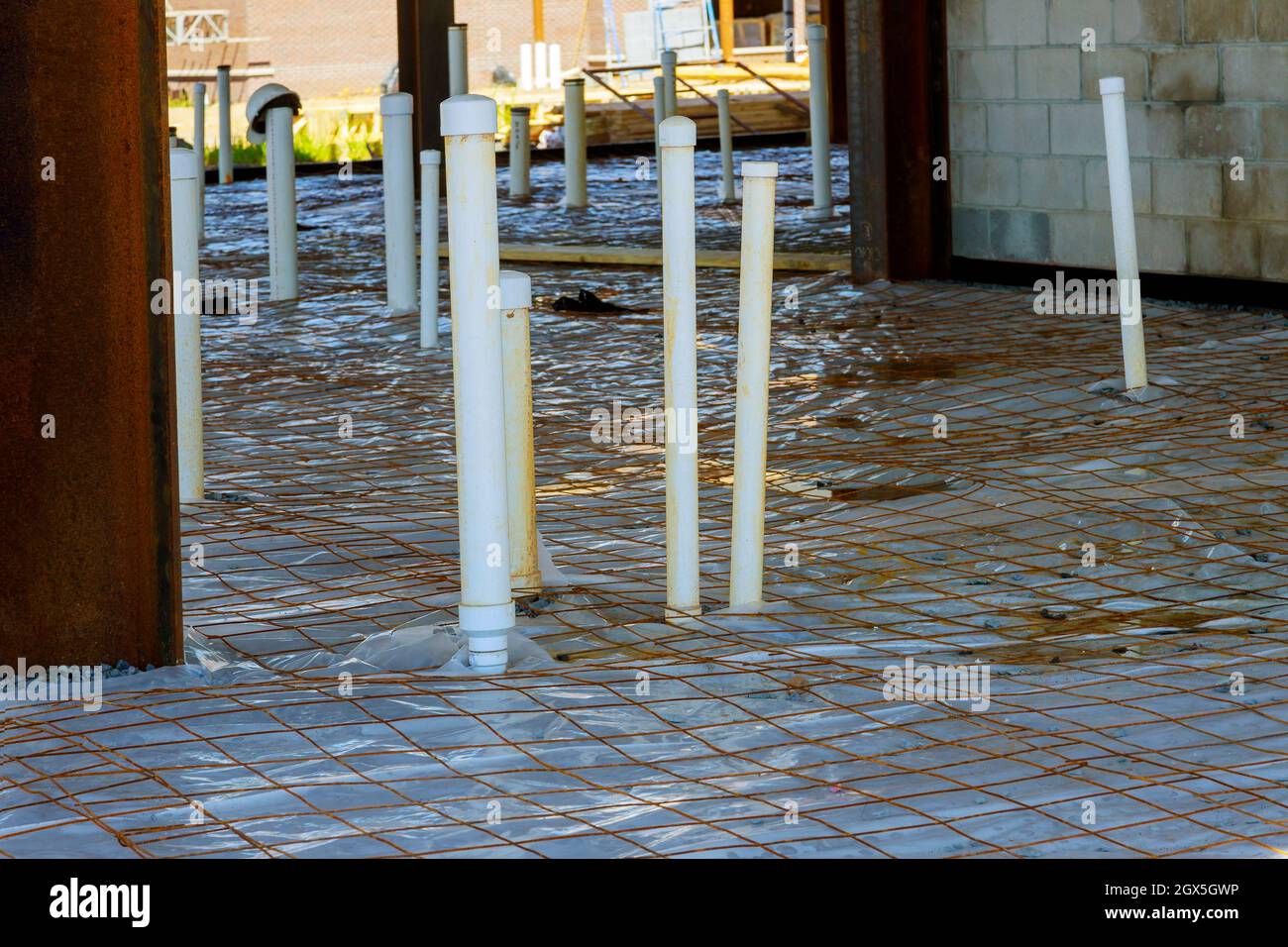 Rough pvc plumbing on slab of house foundation of sanitary pipes Stock