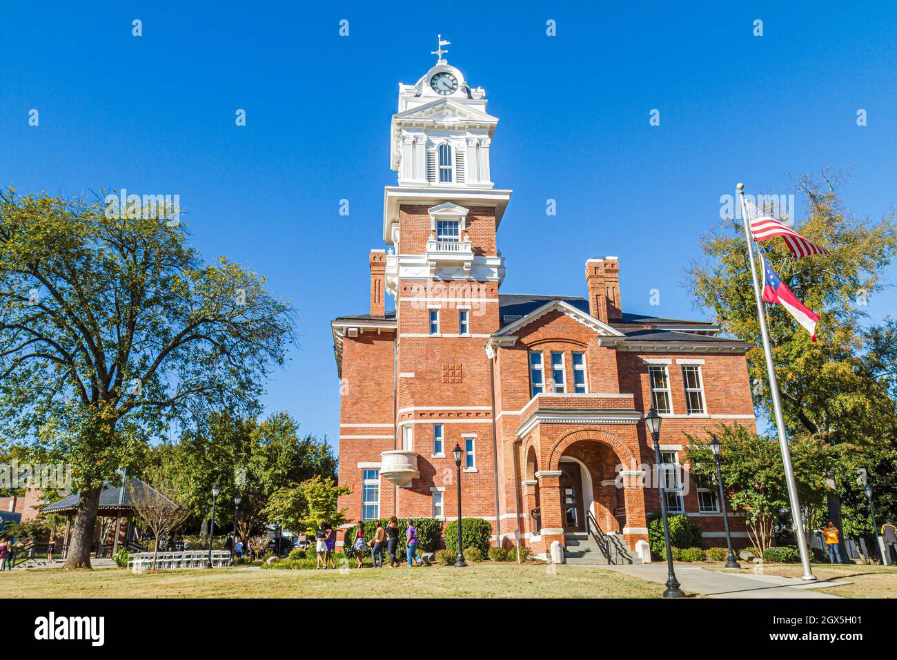 Georgia Lawrenceville,historic Gwinnett County Courthouse,1885 clock tower Romanesque style architecture red brick square flagpole Stock Photo