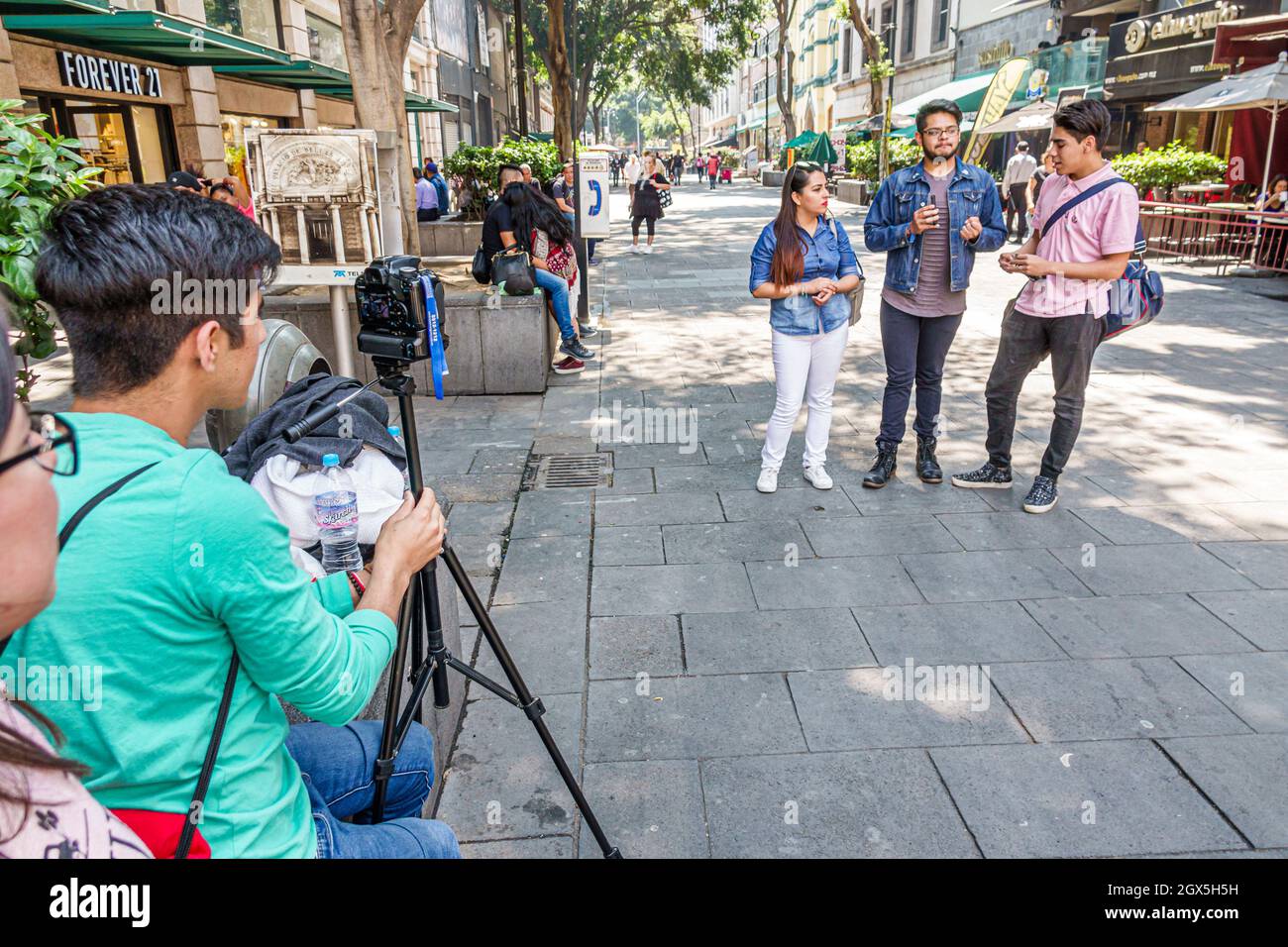 Mexico City,Calle Gante Hispanic boys girls,female teen teens teenagers filming blog blogger students video camera Stock Photo