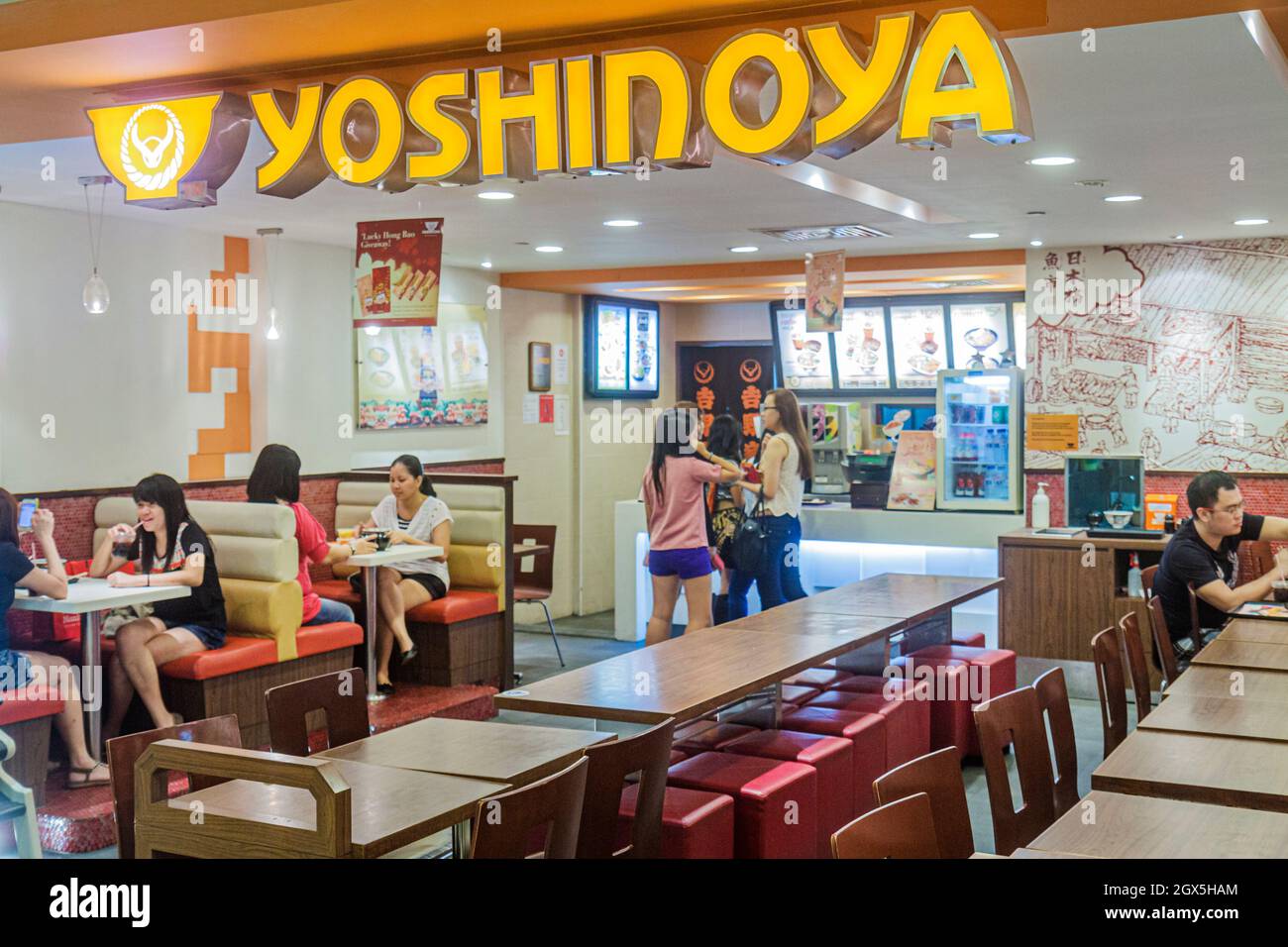 Singapore Bugis Junction Yoshinoya fast food,Japanese restaurant inside  interior tables Asian customers Stock Photo - Alamy