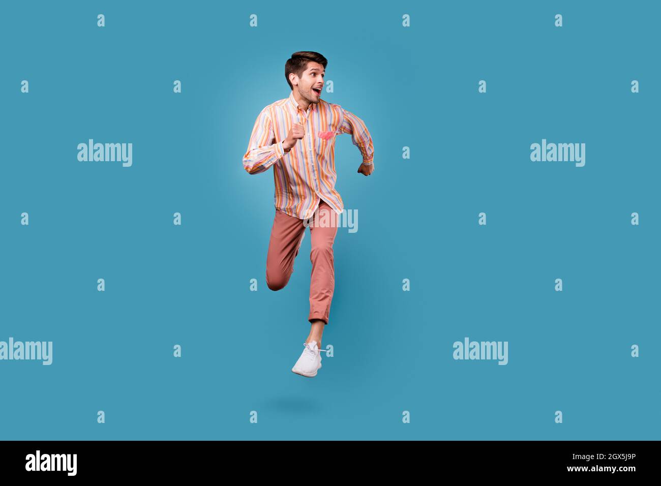 Full body photo of young man happy positive smile jump go walk run look ...