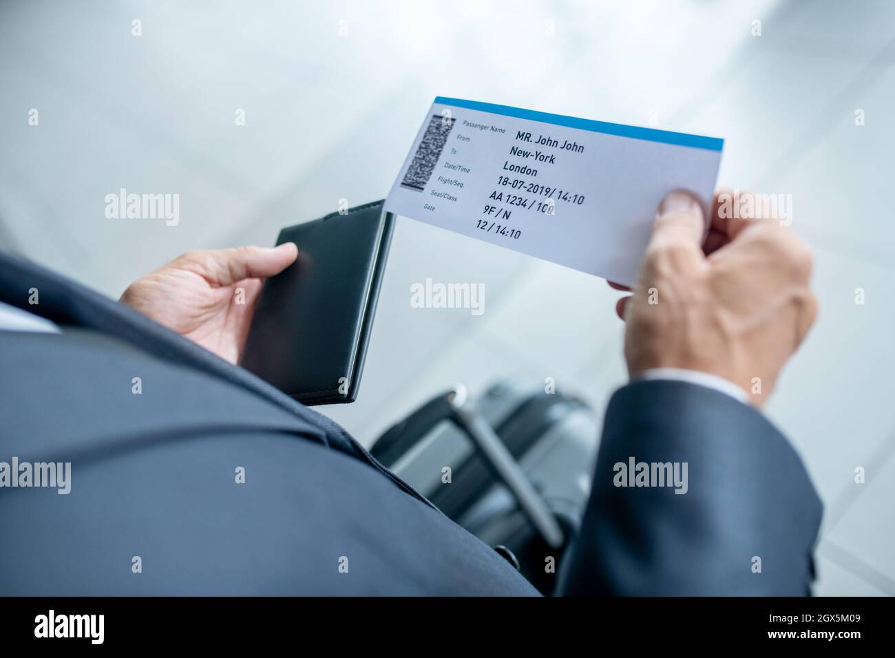 Male hands holding passport and plane ticket Stock Photo