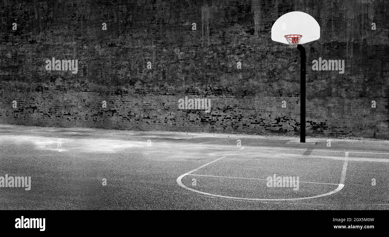 Detail of urban basketball hoop inner city innercity wall and asphalt in outdoor park Stock Photo
