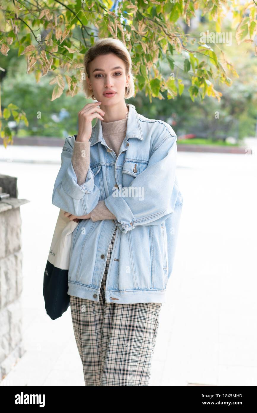 young beautiful woman pose in denim jacket outside Stock Photo Alamy