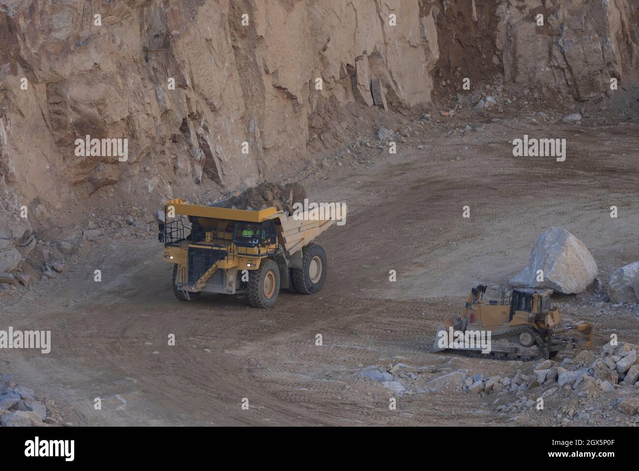 Dumper working over big rocks Stock Photo - Alamy