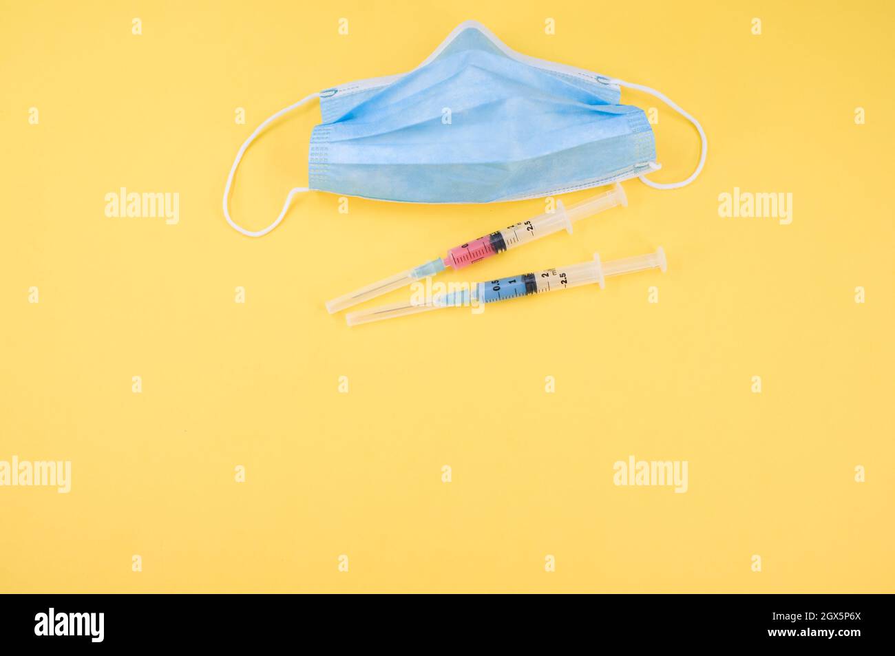Isolated respiratory mask and syringe on a yellow background Stock ...